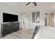 Primary bedroom featuring tray ceilings, wood floors, a dresser and access to walk-in closet at 16486 W 94Th Dr, Arvada, CO 80007
