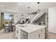 Open-concept kitchen featuring a large island, modern lighting, and seamless flow into the dining and living areas at 16486 W 94Th Dr, Arvada, CO 80007