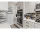 Modern kitchen design boasts stainless steel appliances, built-in oven, and sleek white cabinetry at 16486 W 94Th Dr, Arvada, CO 80007