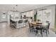 Bright eat-in kitchen showcases an expansive island, stainless steel appliances, and adjacent dining area at 16486 W 94Th Dr, Arvada, CO 80007