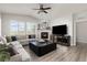 Inviting living room with a cozy fireplace, large windows, and comfortable seating arrangement at 16486 W 94Th Dr, Arvada, CO 80007