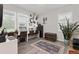 Bright office with white walls, multiple desks, shutters, neutral rug and a decorative collection of clocks at 16486 W 94Th Dr, Arvada, CO 80007