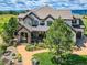 Luxury home with mountain views and a well-manicured lawn at 10887 Rainribbon Rd, Highlands Ranch, CO 80126