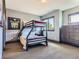 Well-lit bedroom with a bunk bed and ample closet space at 10887 Rainribbon Rd, Highlands Ranch, CO 80126