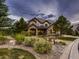 Two-story home with stone exterior and landscaping at 10887 Rainribbon Rd, Highlands Ranch, CO 80126