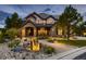 Elegant two-story home with stone facade and a water feature at 10887 Rainribbon Rd, Highlands Ranch, CO 80126