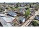 Aerial view of the house and neighborhood, featuring mature trees and detached garages at 45 S Grove St, Denver, CO 80219