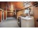 Unfinished basement with utility sink, washer and dryer hookups, and exposed ceiling at 45 S Grove St, Denver, CO 80219