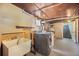 Unfinished basement with utility sink, washer and dryer hookups, and ample storage space at 45 S Grove St, Denver, CO 80219