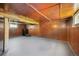Unfinished basement with painted concrete floor and paneled walls, offering potential for customization at 45 S Grove St, Denver, CO 80219