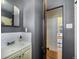 Bathroom view with vanity and doorway to another room with hardwood floors at 45 S Grove St, Denver, CO 80219