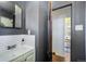 Bathroom view with vanity and doorway to another room with hardwood floors at 45 S Grove St, Denver, CO 80219
