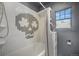 Bathroom with white tile, tub and shower and skull art decoration at 45 S Grove St, Denver, CO 80219