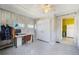 Bedroom with wood-look paneled walls, patterned floor, closet, and desk area, adjacent to kitchen at 45 S Grove St, Denver, CO 80219