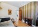 Bedroom view with hardwood floors, bed, desk, and doorway to another room at 45 S Grove St, Denver, CO 80219
