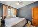 Inviting bedroom with dark walls, a comfortable bed, and natural light from multiple windows at 45 S Grove St, Denver, CO 80219