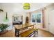Open dining room with a wooden table, bench, and view into the living area with cozy furniture at 45 S Grove St, Denver, CO 80219