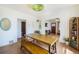 Bright dining area with a large wooden table, bench seating, and stylish decor at 45 S Grove St, Denver, CO 80219