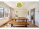 Inviting dining area featuring a wooden table and bench, with natural light from windows and patterned wallpaper at 45 S Grove St, Denver, CO 80219