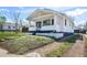 Charming home featuring white siding, front porch, and a well-maintained front yard at 45 S Grove St, Denver, CO 80219