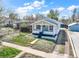 Charming home with white siding, a light blue door, and a detached garage in a residential area at 45 S Grove St, Denver, CO 80219