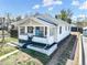 Exterior of a charming home with white siding, a light blue door, and a detached garage at 45 S Grove St, Denver, CO 80219