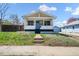 Charming home with a welcoming porch and a bright blue front door, set on a well-maintained lawn at 45 S Grove St, Denver, CO 80219