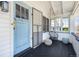 Charming covered front porch with a hanging swing and a light blue front door at 45 S Grove St, Denver, CO 80219