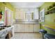 Bright kitchen with sleek appliances, eat-in bar and tile floors at 45 S Grove St, Denver, CO 80219