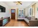 Cozy living room with hardwood floors, a gray sectional sofa, and a classic television set at 45 S Grove St, Denver, CO 80219