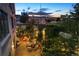 Aerial view of patio showing multiple seating areas, landscaping, and string lights for ambiance at 2000 Little Raven St # 1B, Denver, CO 80202