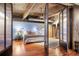 Comfortable bedroom with hardwood floors, modern decor, and industrial-style doors at 2000 Little Raven St # 1B, Denver, CO 80202