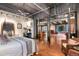 Spacious bedroom showing open concept leading to kitchen and additional sitting area and exposed ductwork at 2000 Little Raven St # 1B, Denver, CO 80202