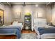 Bedroom featuring two beds, artwork, and stylish decor at 2000 Little Raven St # 1B, Denver, CO 80202