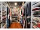 Walk-in closet featuring rows of hanging clothes and organized shelves for shoes and storage at 2000 Little Raven St # 1B, Denver, CO 80202