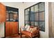 Charming entryway with a wooden bench, pillows and a window with black frames at 2000 Little Raven St # 1B, Denver, CO 80202