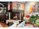 Cozy fireplace with brick surround, decorative art, and comfortable seating at 2000 Little Raven St # 1B, Denver, CO 80202