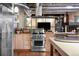 Modern kitchen with stainless steel appliances, hardwood floors, and open layout at 2000 Little Raven St # 1B, Denver, CO 80202