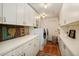 Laundry room featuring modern washer and dryer, wooden floors, and custom white cabinets at 2000 Little Raven St # 1B, Denver, CO 80202