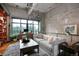 Bright, airy living room featuring an open layout, hardwood floors, and contemporary decor with bicycle accents at 2000 Little Raven St # 1B, Denver, CO 80202