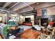 Living room with fireplace, exposed brick, hardwood floors and comfortable furniture at 2000 Little Raven St # 1B, Denver, CO 80202
