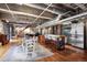 Spacious living area featuring hardwood floors, exposed ductwork, and a kitchen at 2000 Little Raven St # 1B, Denver, CO 80202