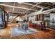 Open living area with hardwood floors, kitchen, bar seating and exposed ductwork at 2000 Little Raven St # 1B, Denver, CO 80202