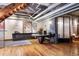 Office area features a large desk, custom cabinets, and exposed ductwork, blending function with industrial design at 2000 Little Raven St # 1B, Denver, CO 80202