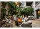 Cozy outdoor patio area boasts lush greenery, comfortable seating, and a warm fire pit at 2000 Little Raven St # 1B, Denver, CO 80202