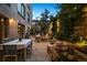 Exterior patio featuring dining and seating areas surrounded by lush landscaping and string lights at 2000 Little Raven St # 1B, Denver, CO 80202