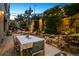 Backyard patio for evening entertaining, complete with comfortable seating, string lights, and lush landscaping at 2000 Little Raven St # 1B, Denver, CO 80202
