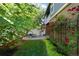 Beautiful backyard featuring a cozy patio with seating, lush greenery, and vibrant climbing roses at 7746 E Severn Pl, Denver, CO 80230