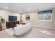 Spacious finished basement with comfortable seating, perfect for a home theater or recreation area at 7746 E Severn Pl, Denver, CO 80230