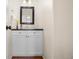 Elegant powder room featuring a sleek vanity with black countertop and modern fixtures at 7746 E Severn Pl, Denver, CO 80230